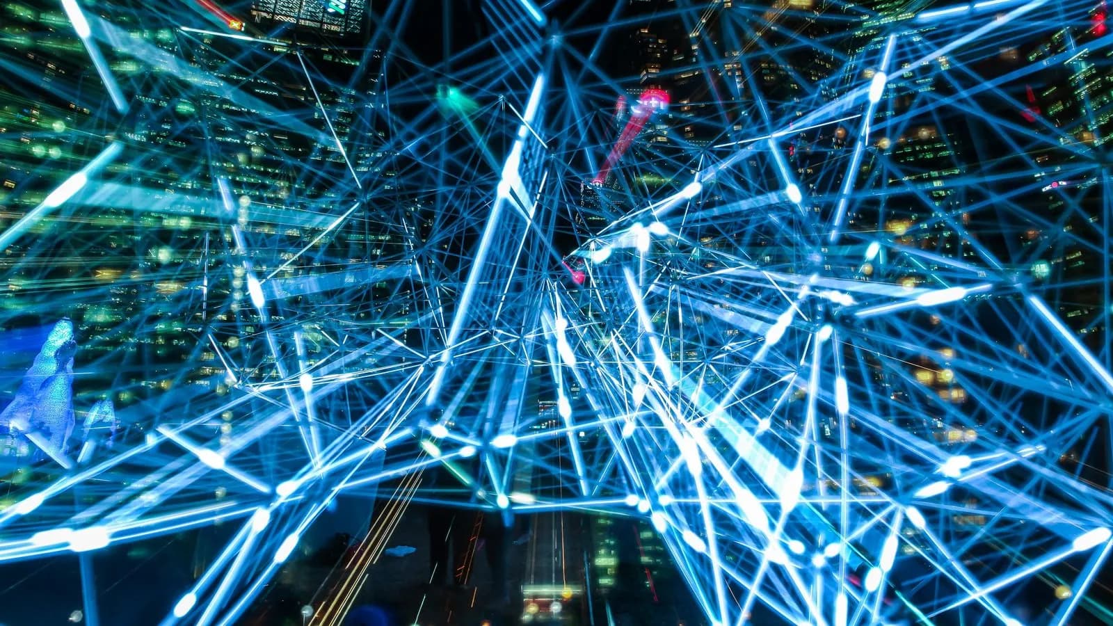 Glowing web of interconnected data streams and nodes over a city at night, evoking real-time buyer intent signals