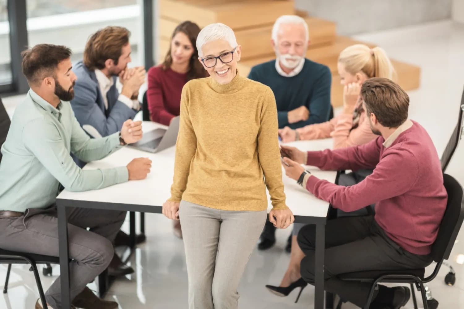 A cross-company team collaborating around a table, representing a partner ecosystem