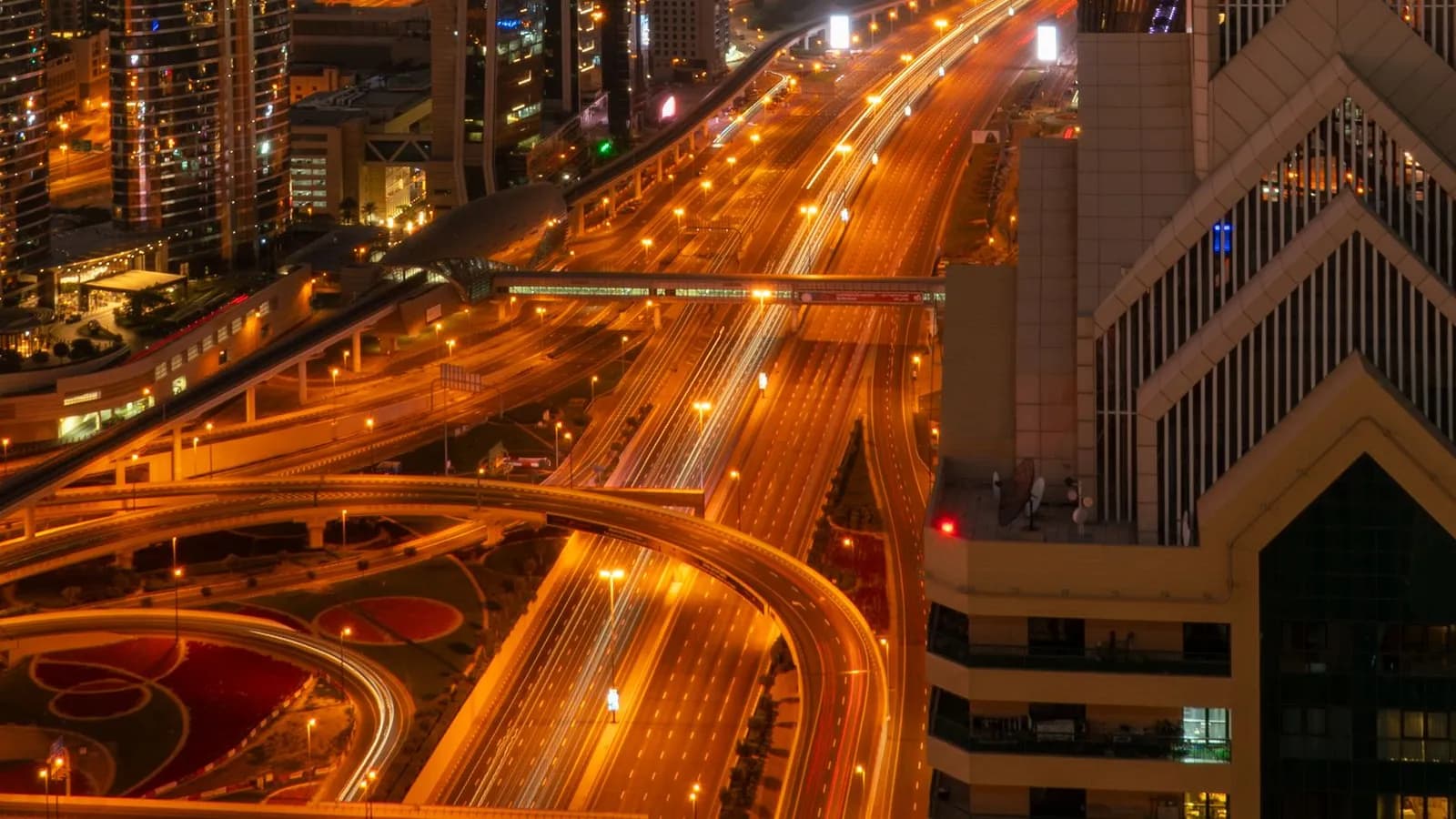 Illuminated highways streaking through a modern city skyline at night, representing AI-driven B2B marketing systems
