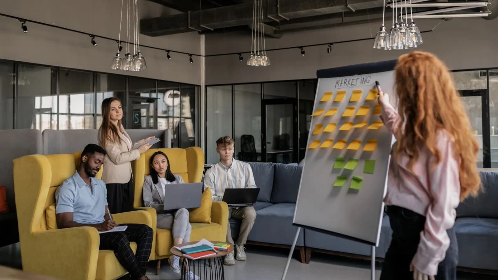 Marketing and sales colleagues gathered around a sticky-note strategy board as one revenue team
