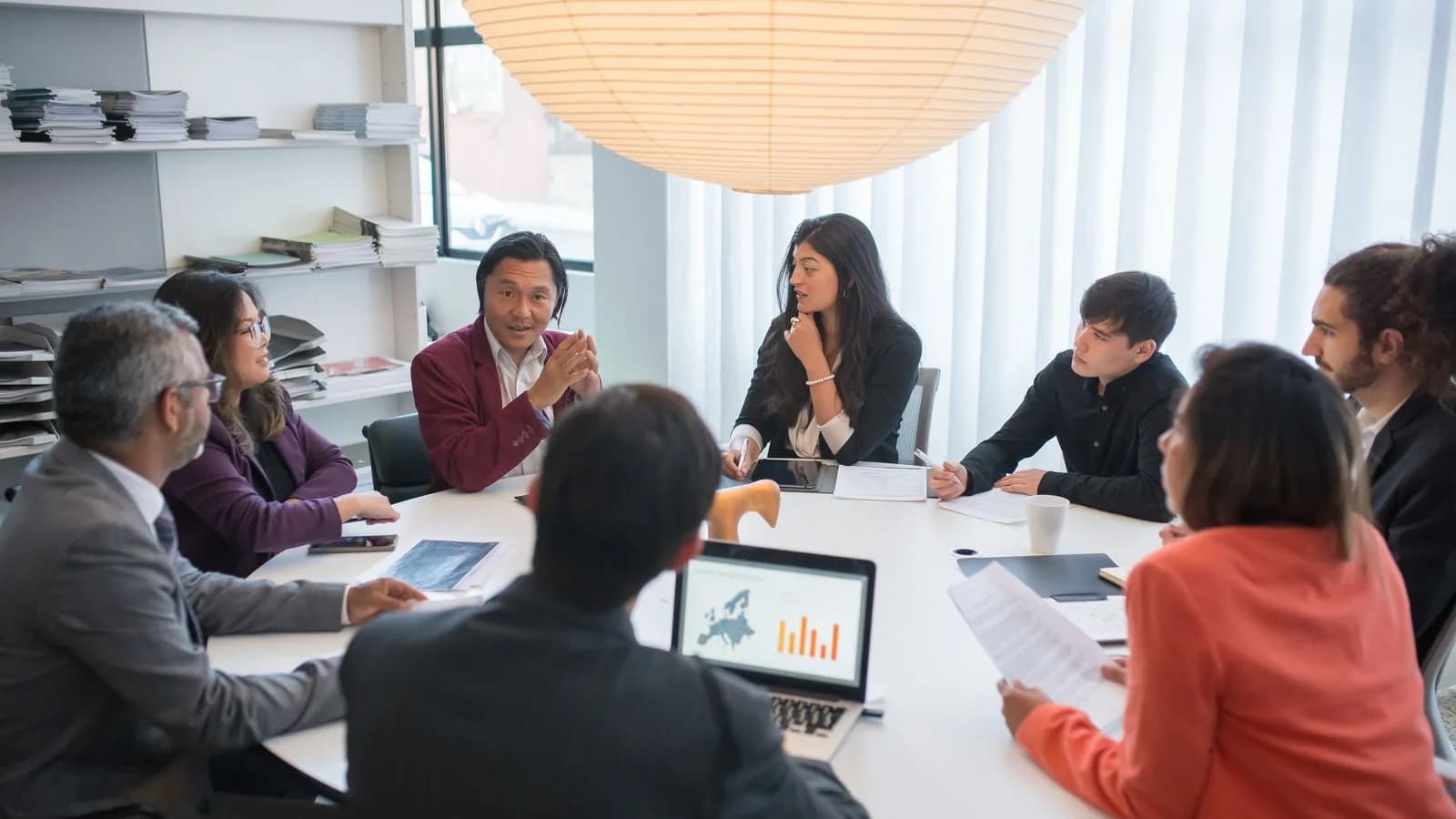 A cross-functional team around a conference table aligning marketing, sales, and data on target accounts