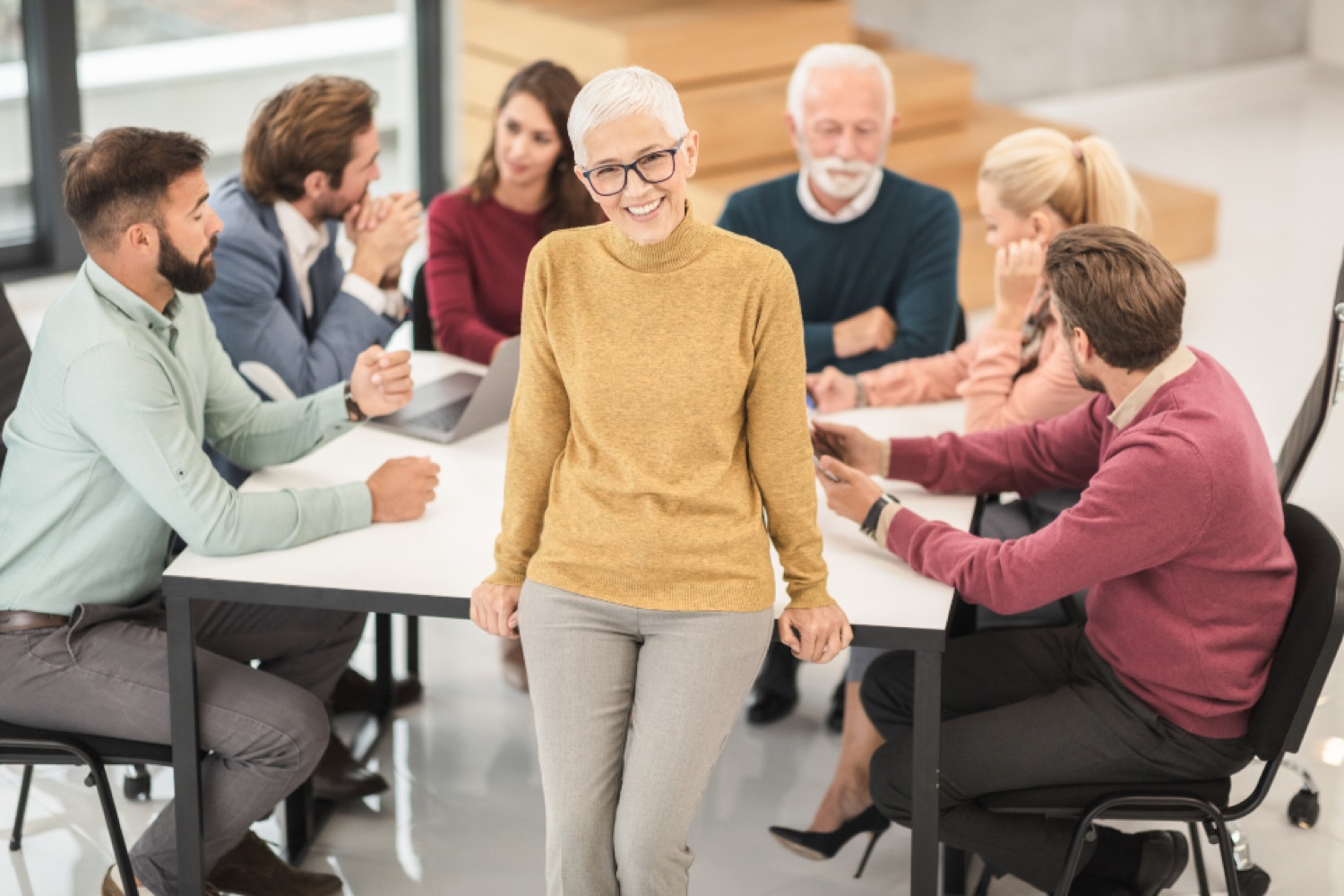 A cross-company team collaborating around a table, representing a partner ecosystem